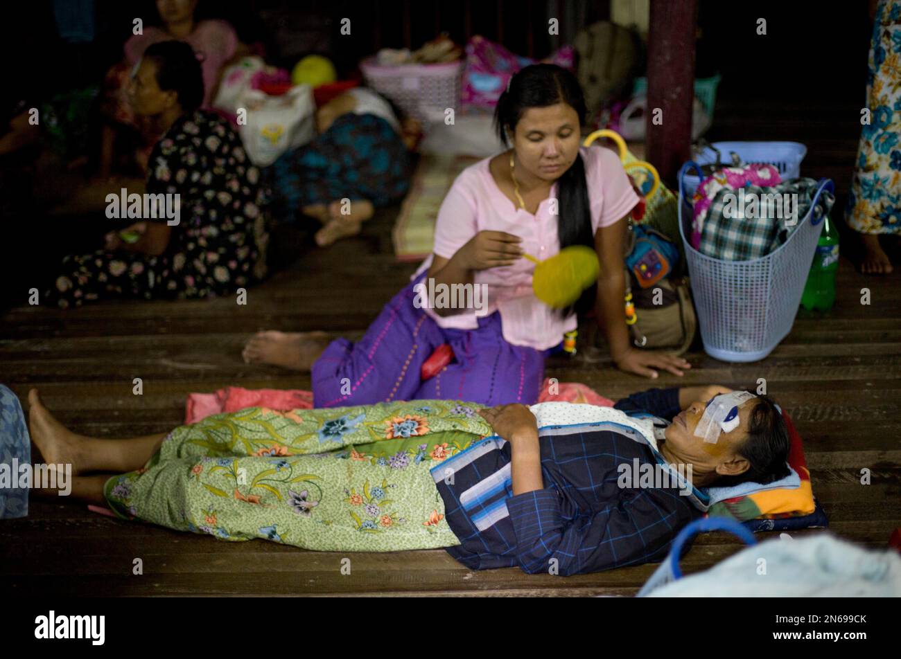 In this Oct. 22, 2013 photo, a relative fans a patient with an eye