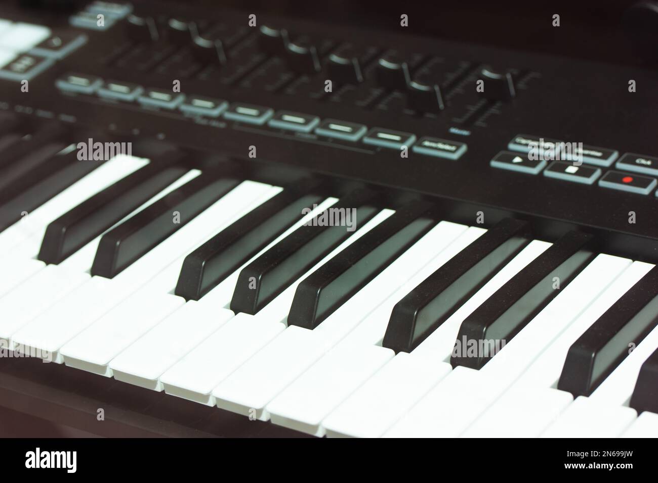 Black white keys piano, synthesizer up close in recording studio.Professional HiFi sound