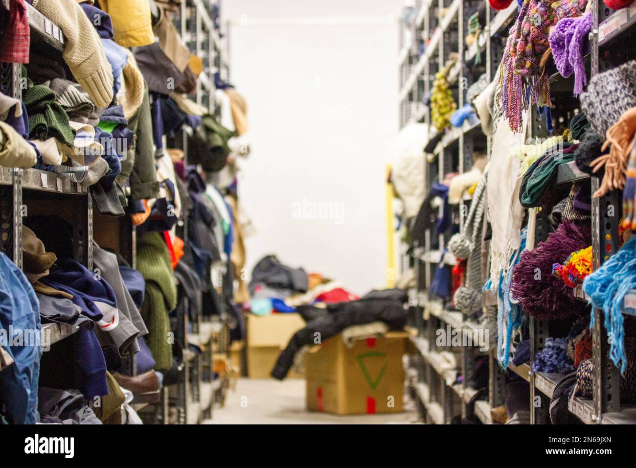 Humanitarian aid station warehouse used clothes, poor refugees Shelves