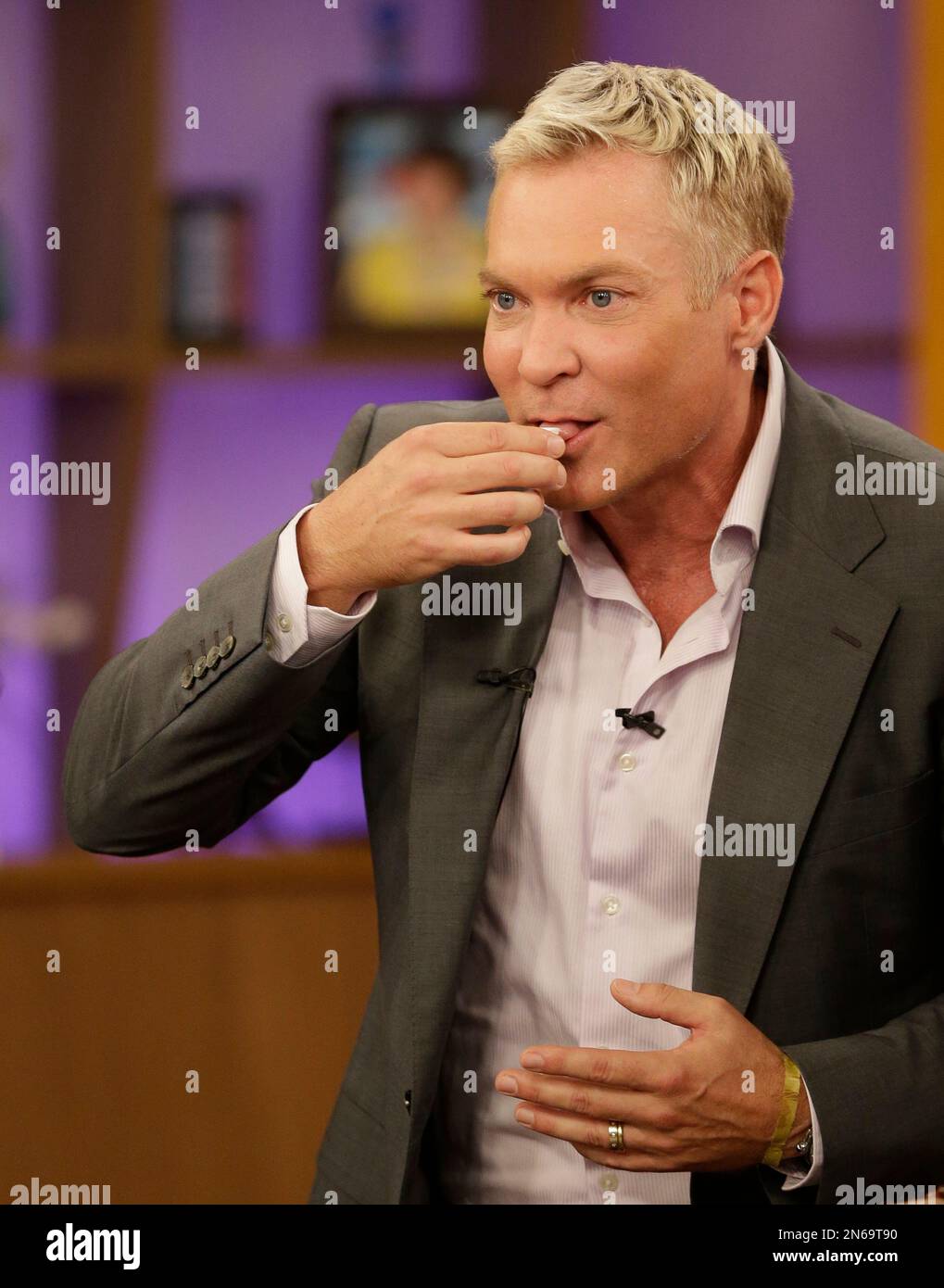 Sam Champion, of the ABC network's "Good Morning America," drinks a small  cup of Cuban coffee on the Univision network morning show, "Despierta  America" ("Wake Up America,") during a joint live broadcast