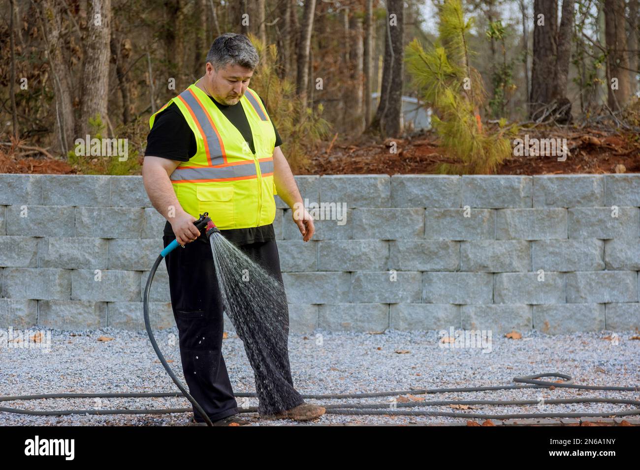 Watering lawn after sowing grass seeds into ground Stock Photo Alamy