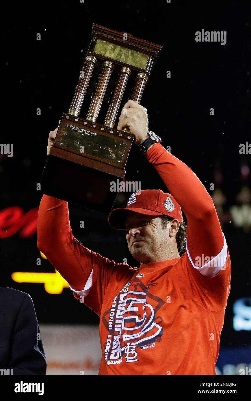 St. Louis Cardinals manager Mike Matheny holds up the championship trophy  after Game 6 of the National League baseball championship series against  the Los Angeles Dodgers Friday, Oct. 18, 2013, in St.
