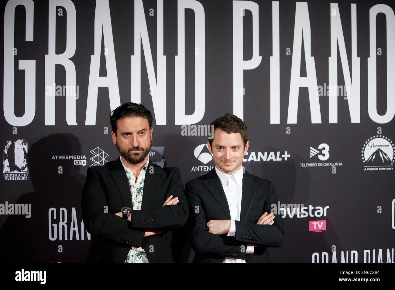 Spanish director Eugenio Mira (L) and U.S. actor Elijah Wood (R) pose at  the premiere of the film 'Grand Piano' at the Callao cinema in Madrid,  Spain, Thursday Oct 15, 2013. (AP
