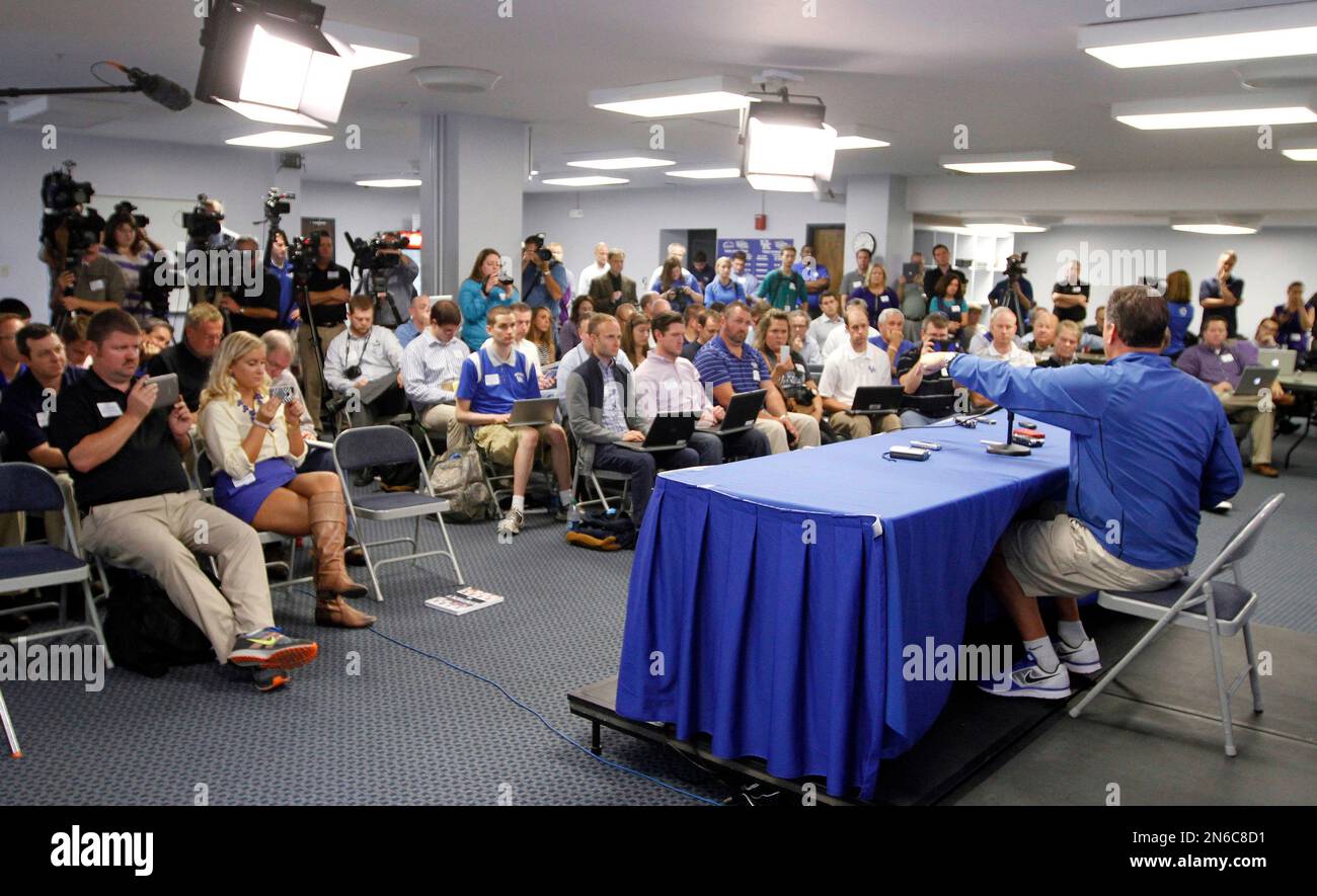 Kentucky coach John Calipari, right, addresses a reporter's question