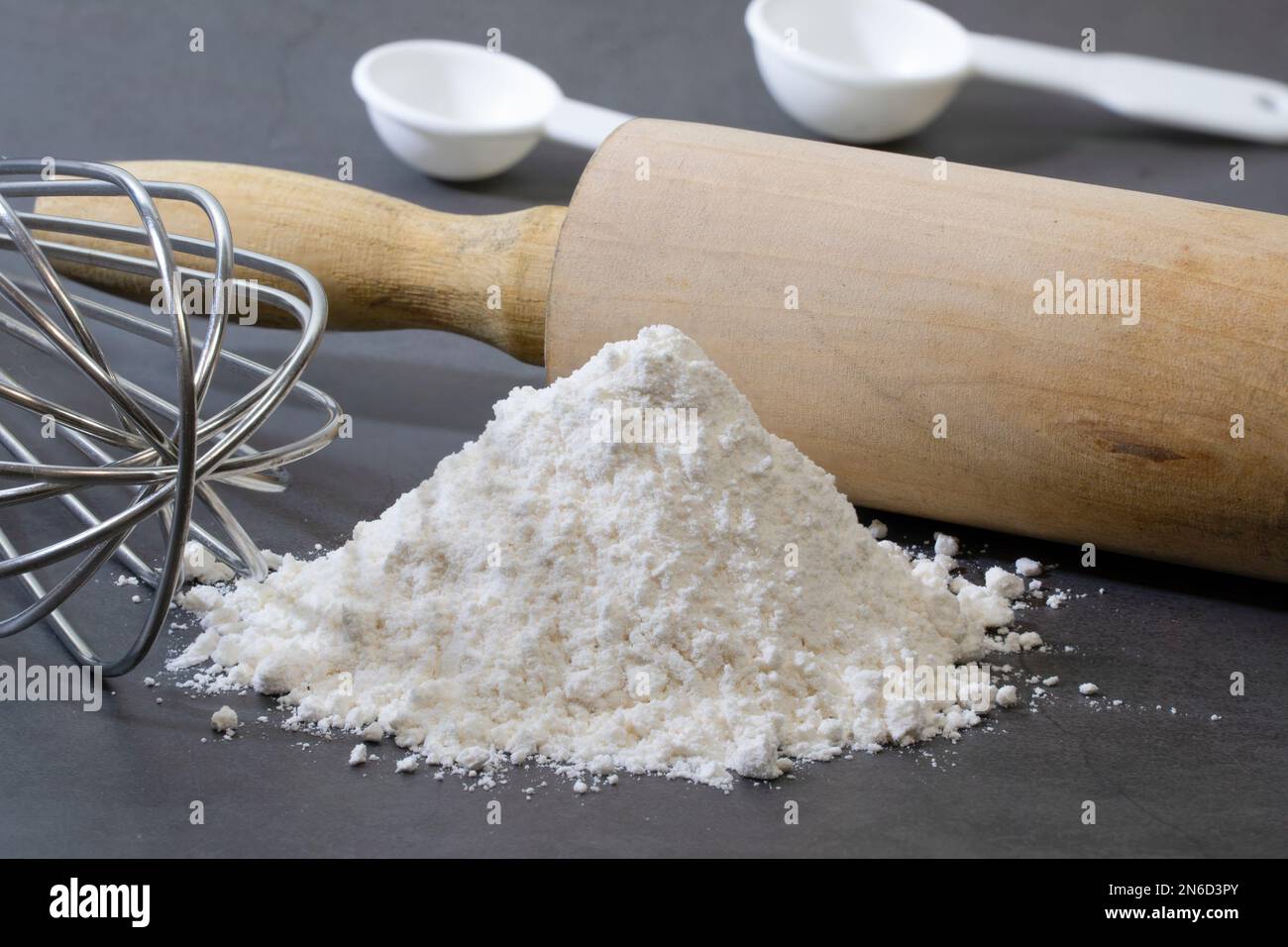 Pile of all-purpose flour for making homemade bread on dark background. Stock Photo