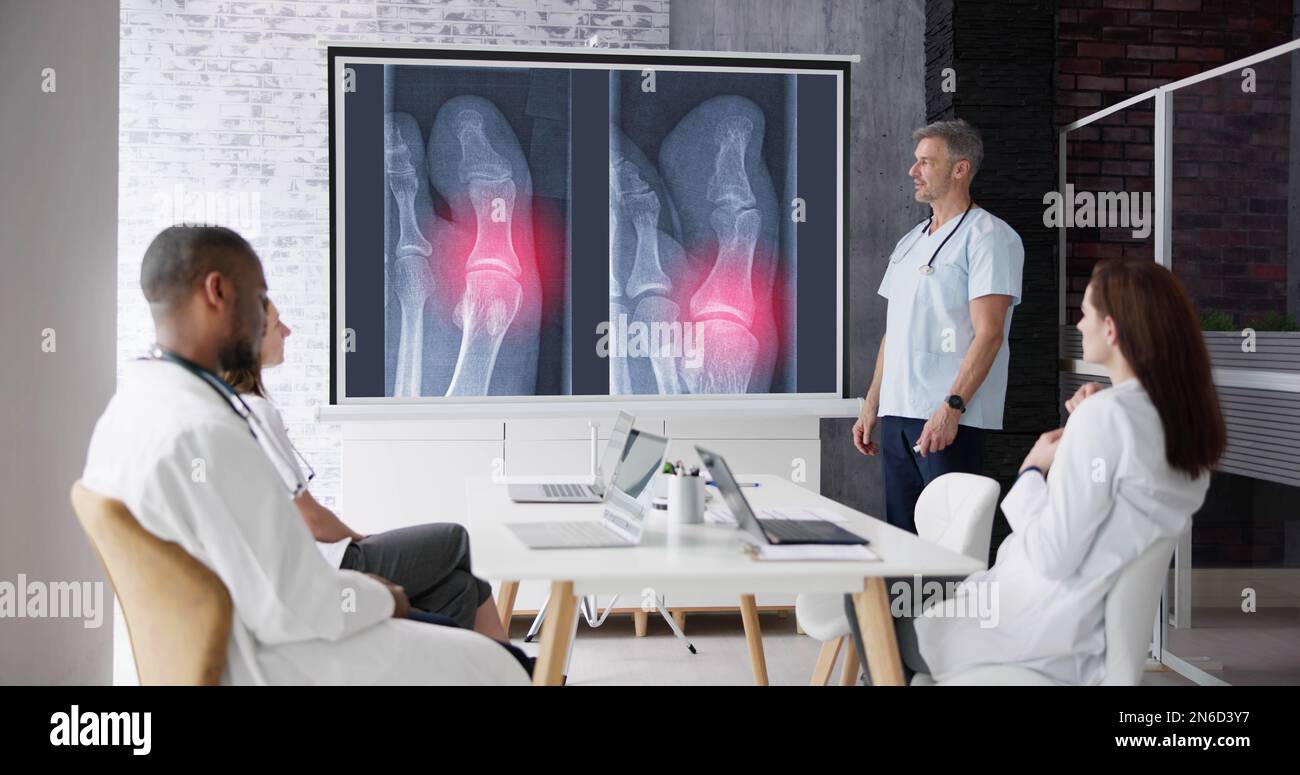 Doctors And Radiologists Discussing X-ray Images Of Patient Stock Photo ...