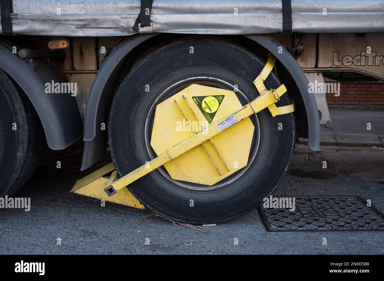 A detail of the immobilizer clamp placed on the wheel of a truck Stock