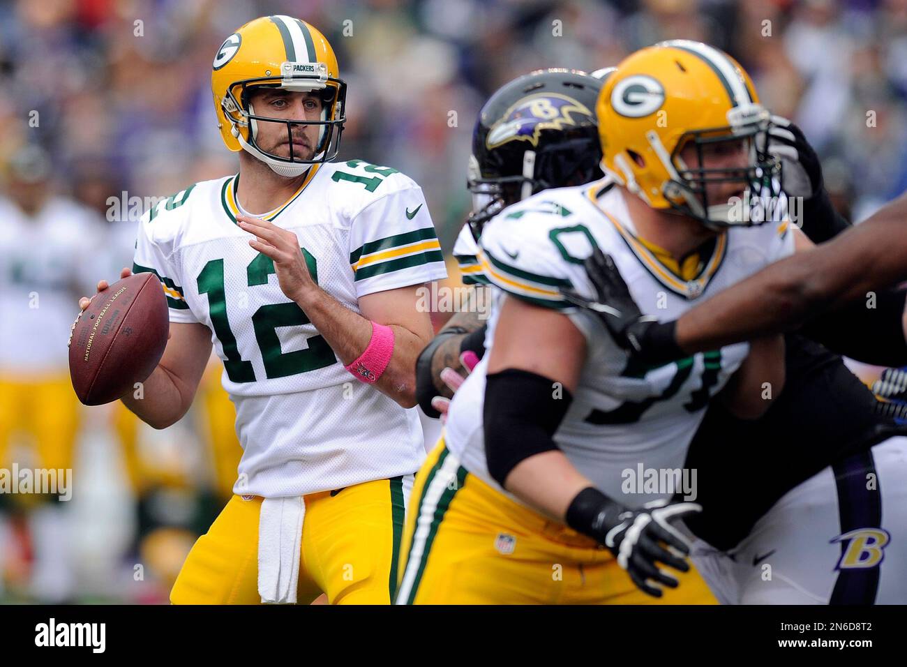 Green Bay Packers quarterback Aaron Rodgers looks for an opening to ...