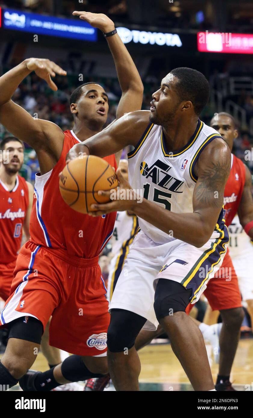 Utah Jazz's Derrick Favors, right, looks to pass the ball away from Los Angeles Clippers' Brandon Davies, left, in the second half of an NBA preseason basketball game Saturday, Oct. 12, 2013, in Salt Lake City. The Clippers won 106-74. (AP Photo/Kim Raff) Stock Photo