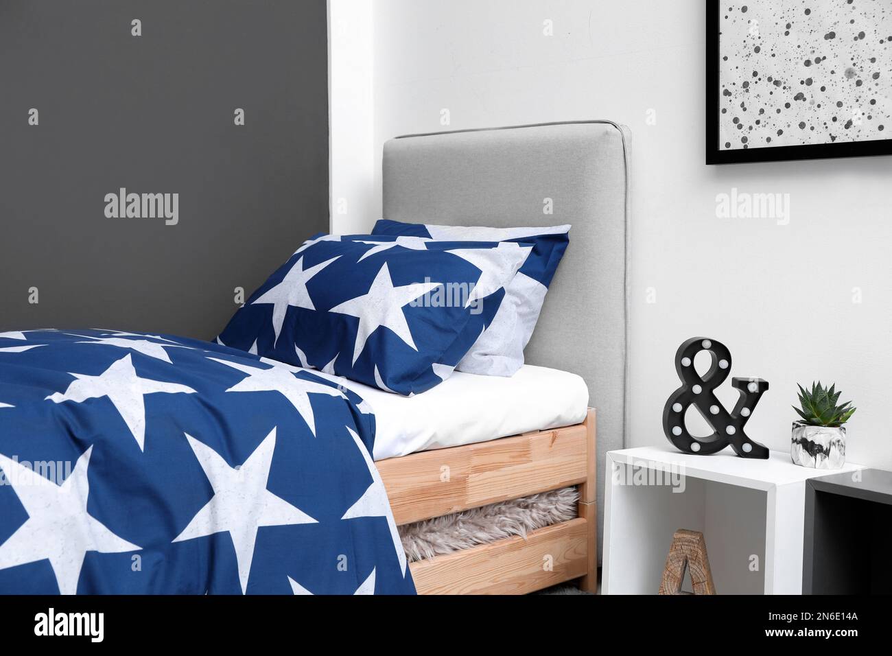 Bed with stylish linens in children's room Stock Photo Alamy