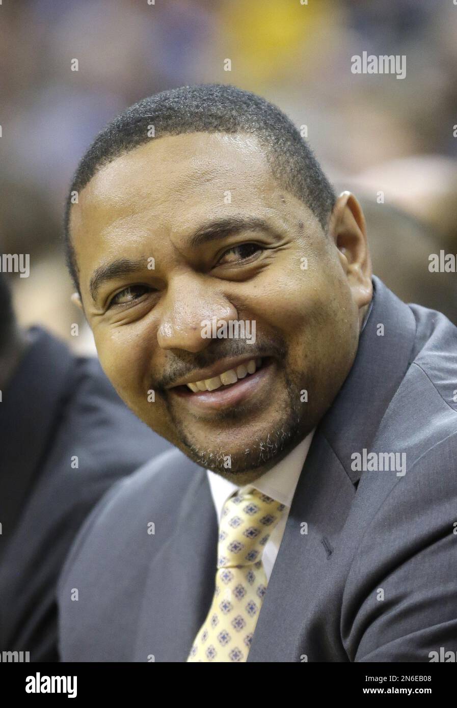 Golden State Warriors head coach Mark Jackson smiles as he sits on the