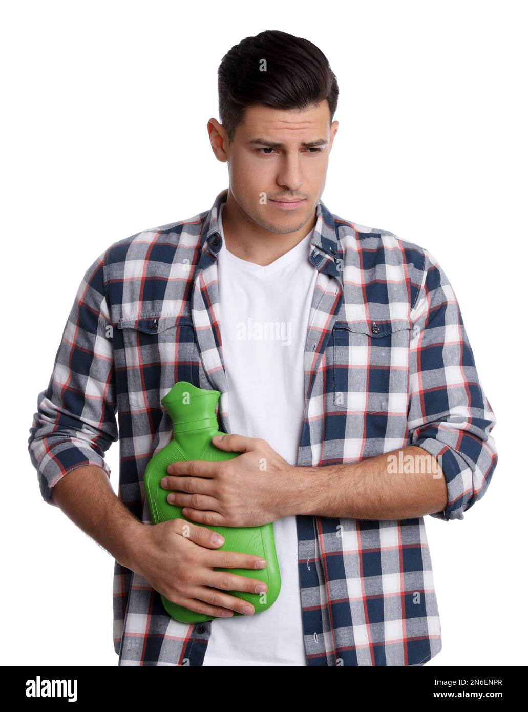 Man using hot water bottle to relieve abdominal pain on white