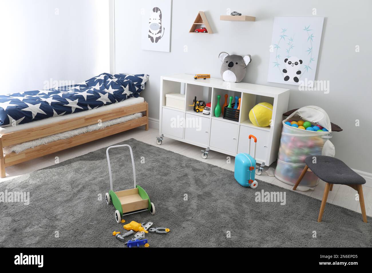Cute child's room interior with toys and modern furniture Stock Photo ...