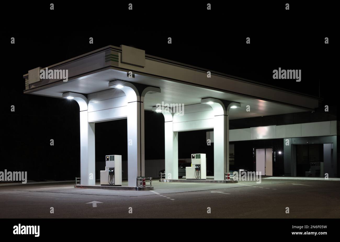 Modern gas station with convenience store beside the road at night