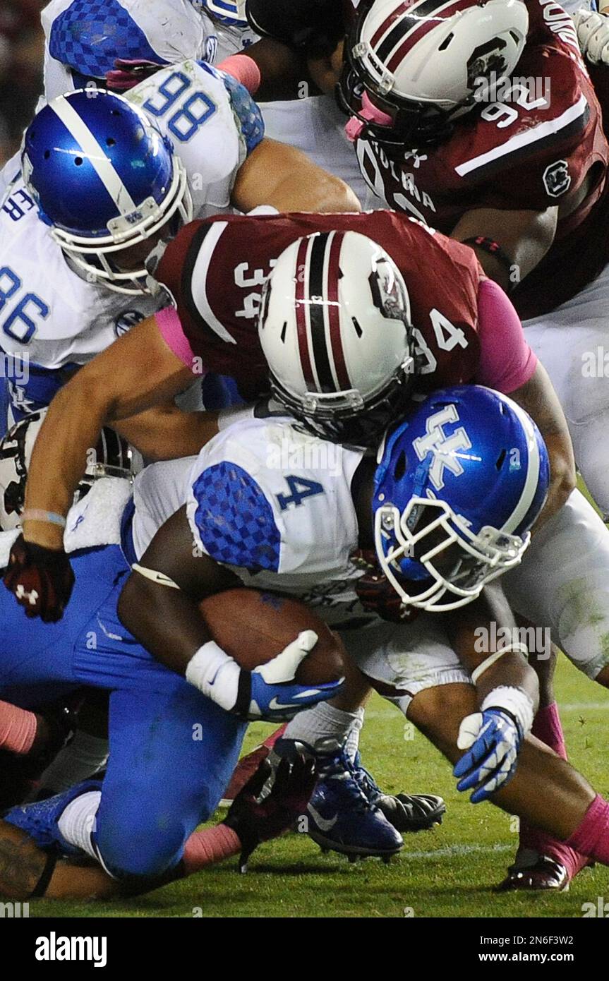 Kentucky running back Raymond Sanders (4) is tackled by South Carolina