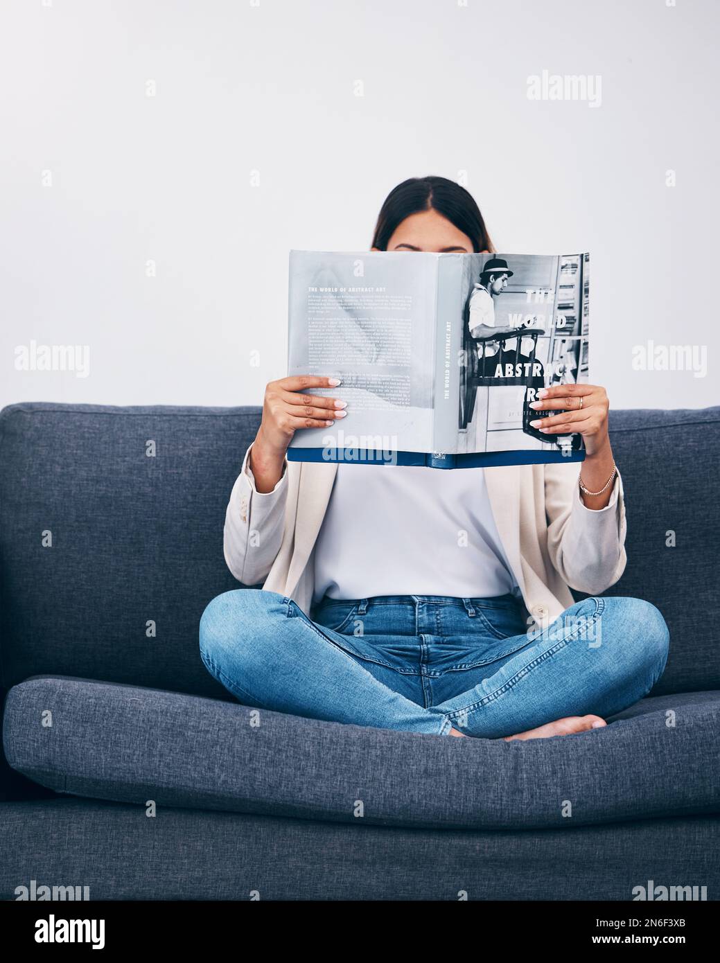 Relax, magazine or woman reading newspaper articles on sofa at home for information or story updates. Press, focus or person relaxing and studying Stock Photo