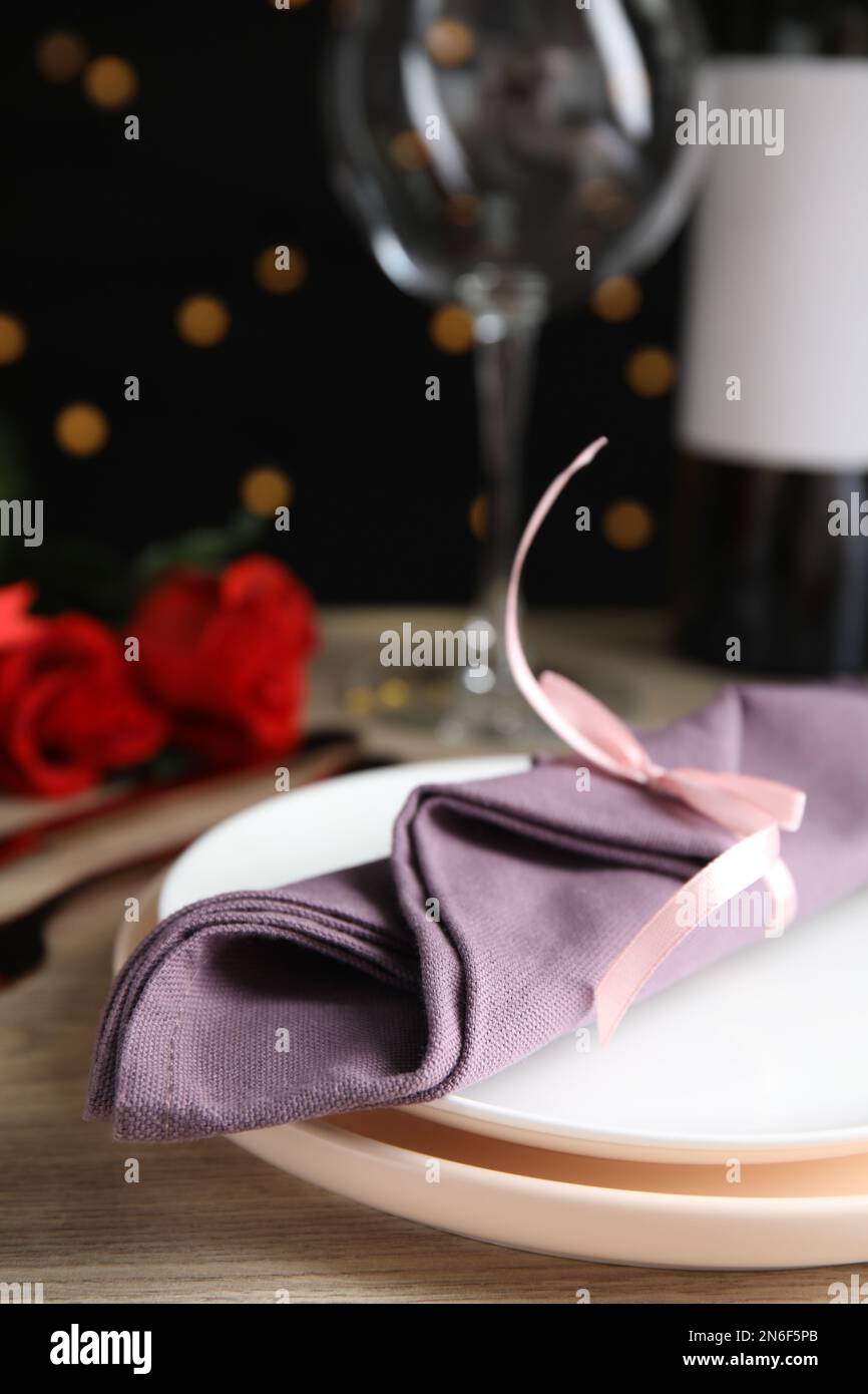 Beautiful place setting for romantic dinner on table against black ...