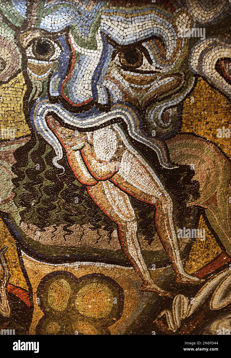 Head of Satan, detail of the section ‘Hell with Satan’ one the the mosaics that adorn the dome of St. John's Baptistery (San Giovanni), one of the most ancient churches in Florence, Italy, on February 8, 2023. Horned Satan, depicted chewing on sinners is widely believed to have been a source of inspiration for the representation of Hell in Dante Alighieri’s Divine Comedy. The mosaics have suffered from rainwater infiltration, and have also been damaged by earthquakes and the flood that devastated the city in 1966. The mosaic ceiling of the Florence Baptistery, a set of mosaics covering the int Stock Photo