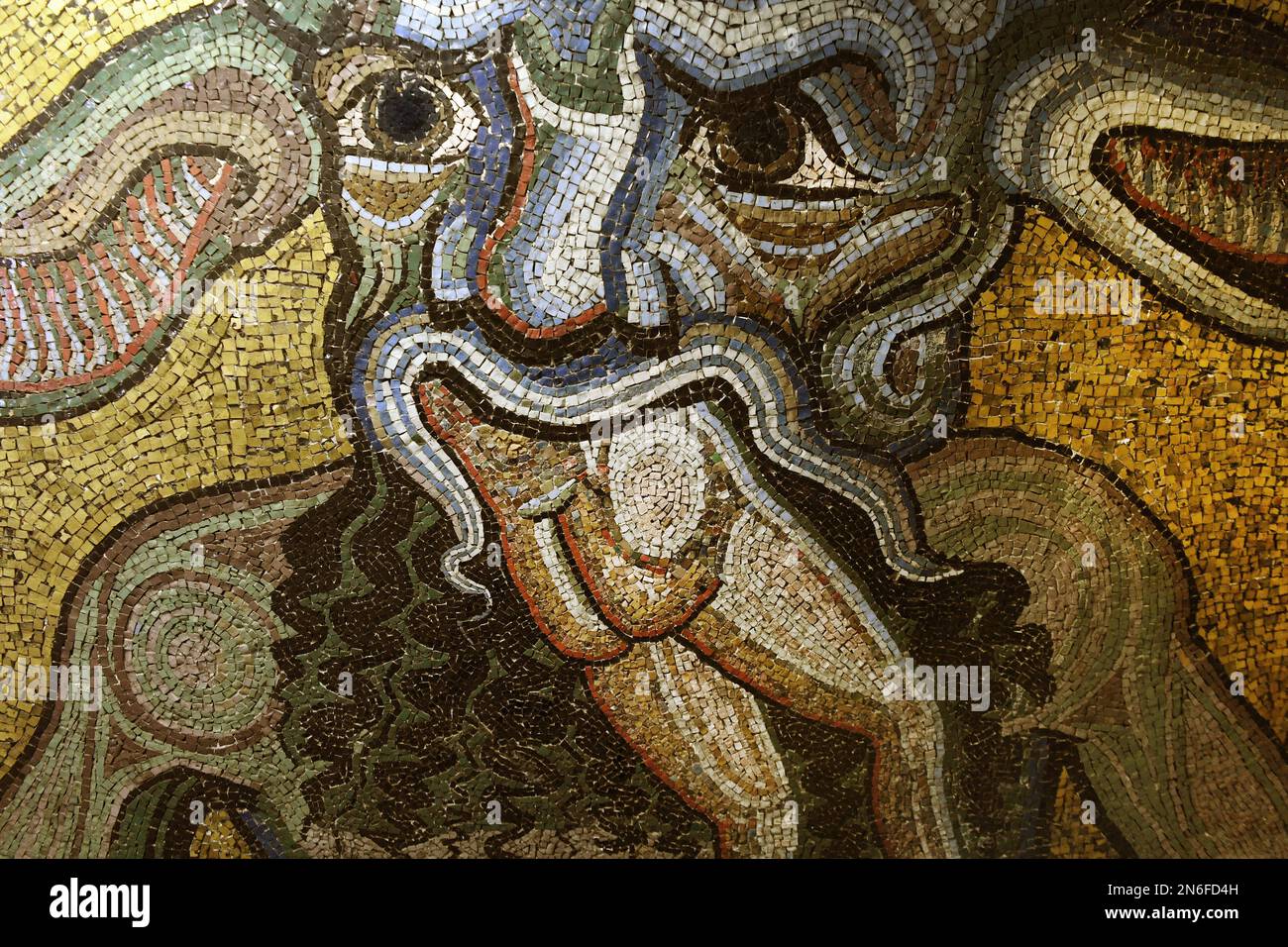 Head of Satan, detail of the section ‘Hell with Satan’ one the the mosaics that adorn the dome of St. John's Baptistery (San Giovanni), one of the most ancient churches in Florence, Italy, on February 8, 2023. Horned Satan, depicted chewing on sinners is widely believed to have been a source of inspiration for the representation of Hell in Dante Alighieri’s Divine Comedy. The mosaics have suffered from rainwater infiltration, and have also been damaged by earthquakes and the flood that devastated the city in 1966. The mosaic ceiling of the Florence Baptistery, a set of mosaics covering the int Stock Photo