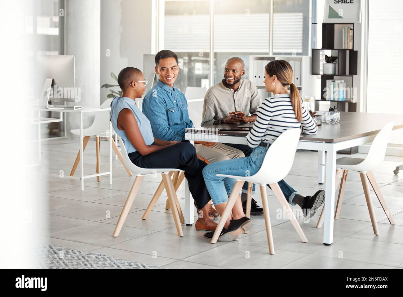 Group of diverse happy businesspeople having a meeting in an office at ...