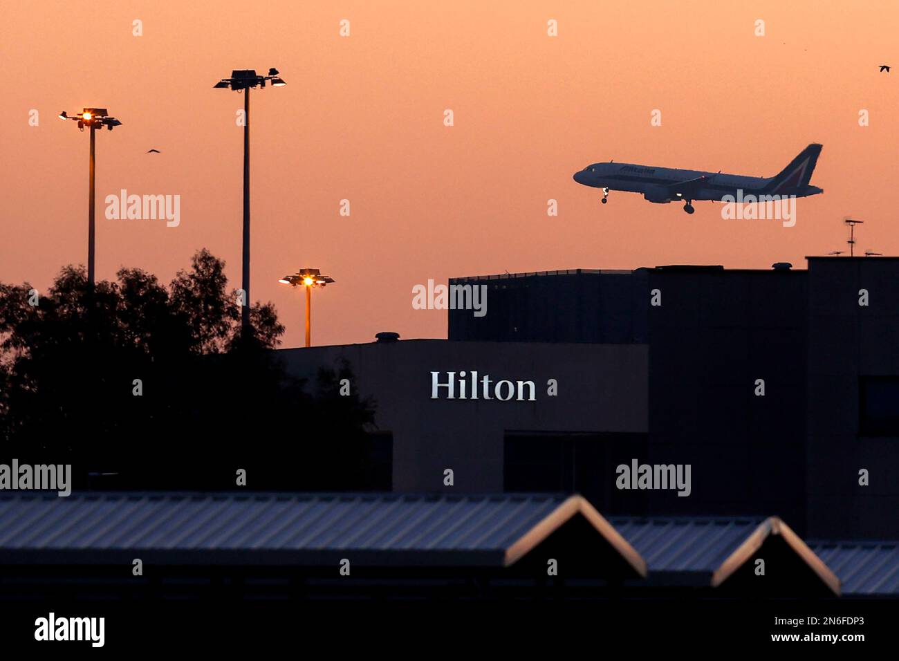 Rome, Italy, January 31, 2023. An aircraft of Italian state-owned flag carrier ITA overflies the Hilton Rome Airport Hotel as it lands at RomeÕs Fiumi Stock Photo