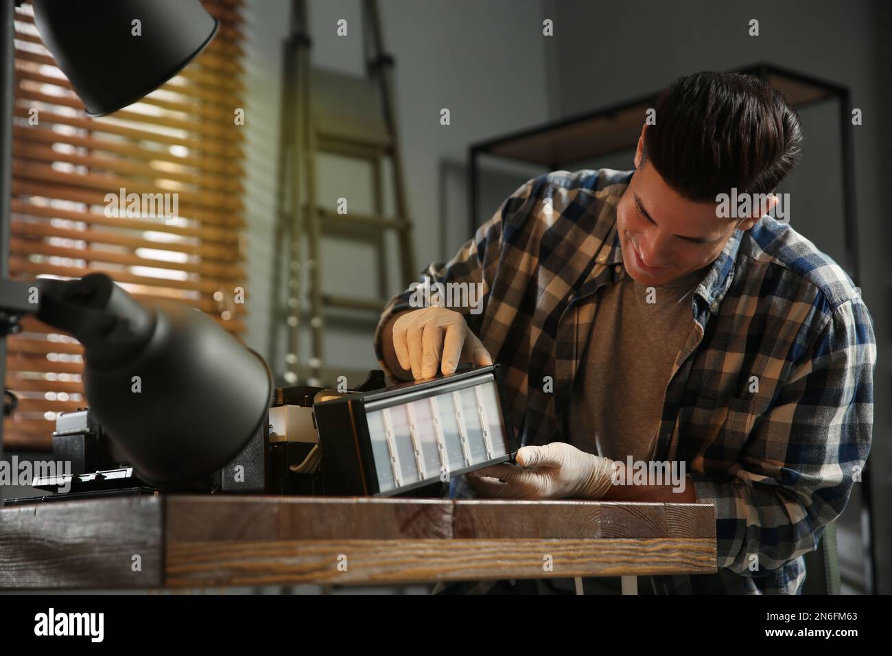 Professional repairman fixing modern printer in office Stock Photo