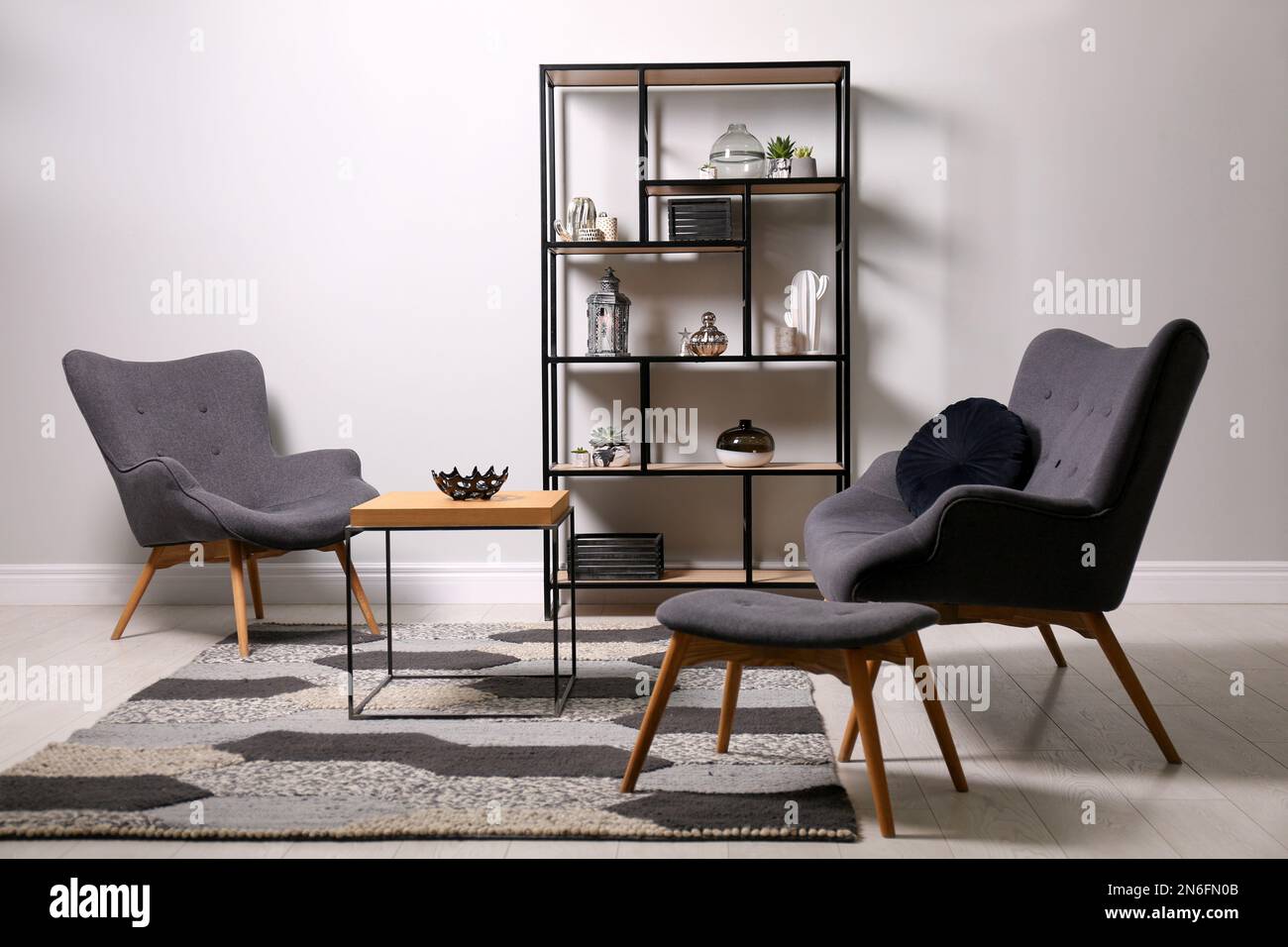 Stylish room with armchairs, coffee table and shelving. Interior design