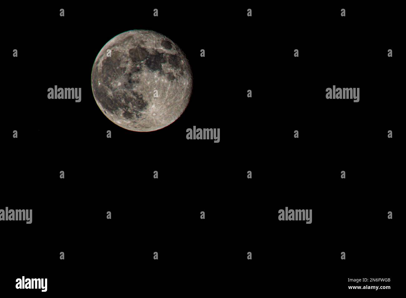 A full moon in the dark black sky at night Stock Photo - Alamy
