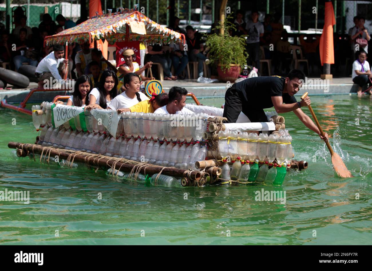 Filipinos paddle on a small boat they made with used plastic bottles and  other recycled materials to join a boat-making competition in Manila,  Philippines on Wednesday, Oct. 2, 2013. The event aims
