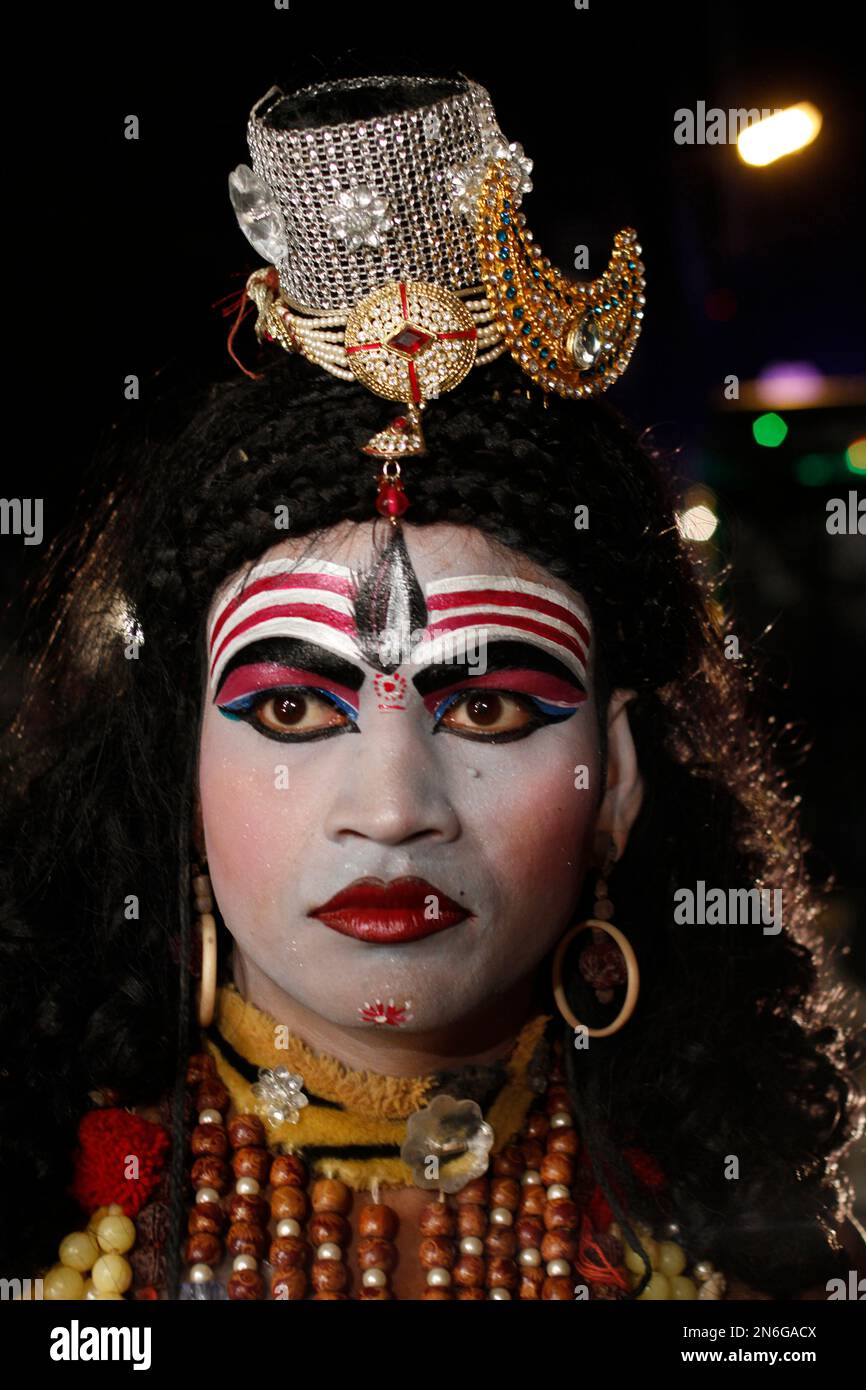 An Indian artiste dressed as Hindu god Shiva waits to participate ...
