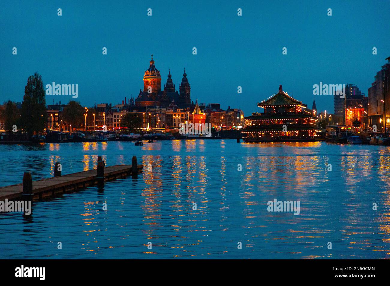 View over Oosterdok and city skyline at night, Amsterdam, Netherlands Stock Photo