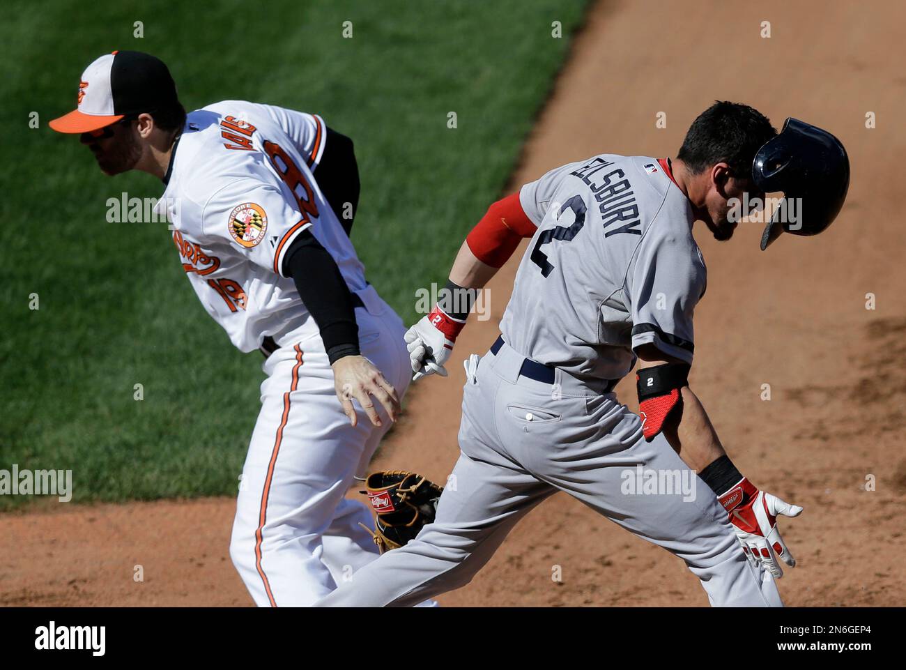 Boston Red Sox' Jacoby Ellsbury, front, runs across first base as