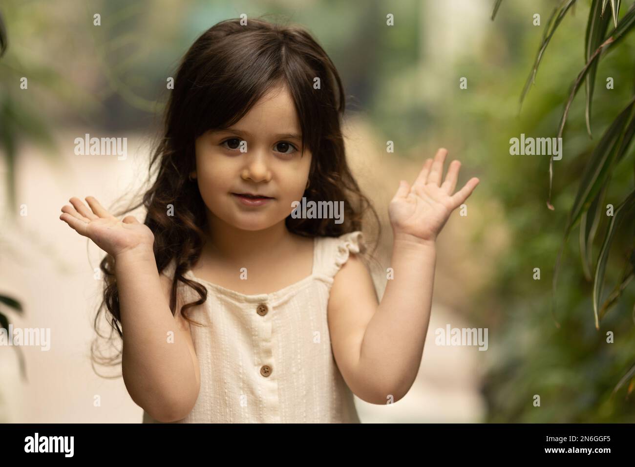 a little girl walks in the botanical garden. happy baby and palm trees Stock Photo