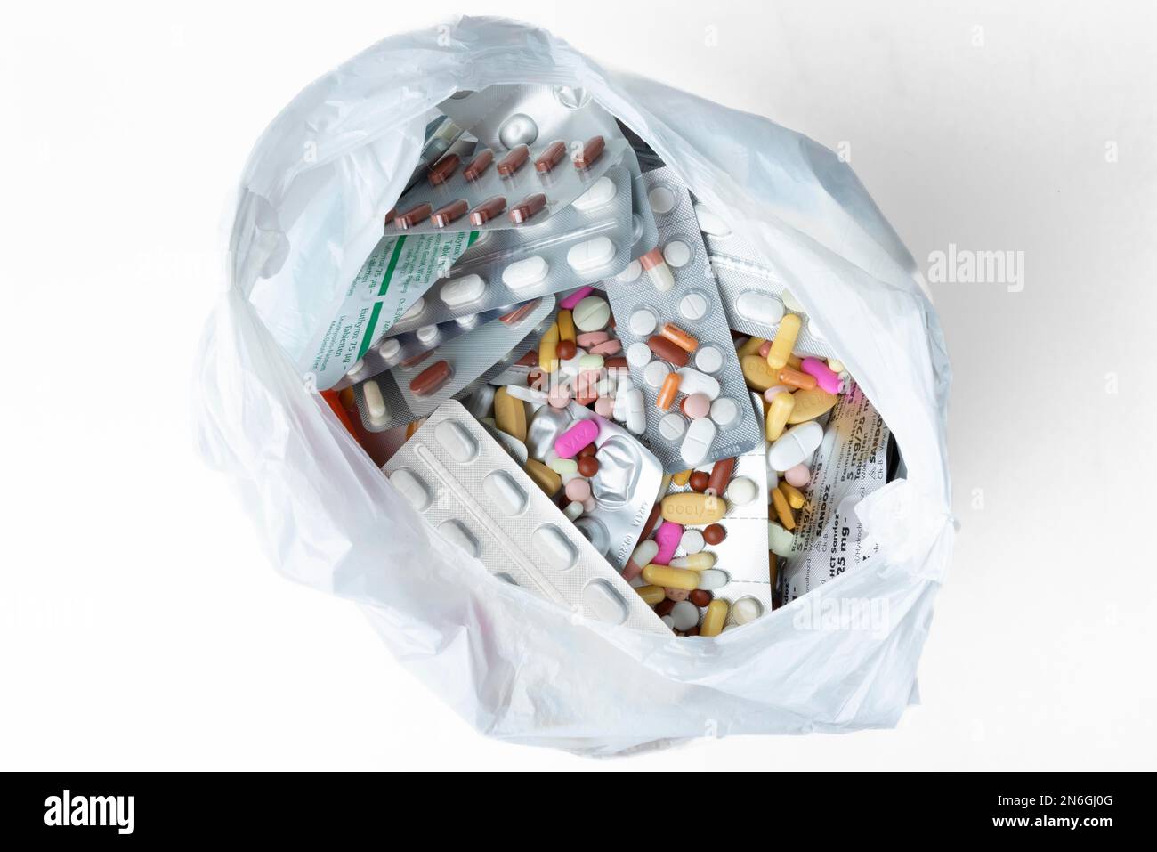 Coloured pills and capsules with and without packaging in rubbish bag