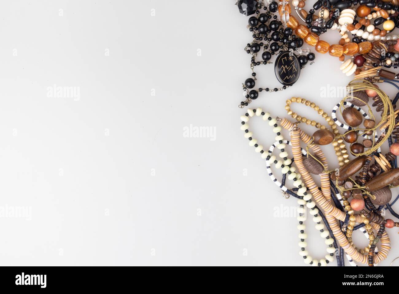 Many necklaces, beads, costume jewellery, arranged sideways, with free space, white background Stock Photo