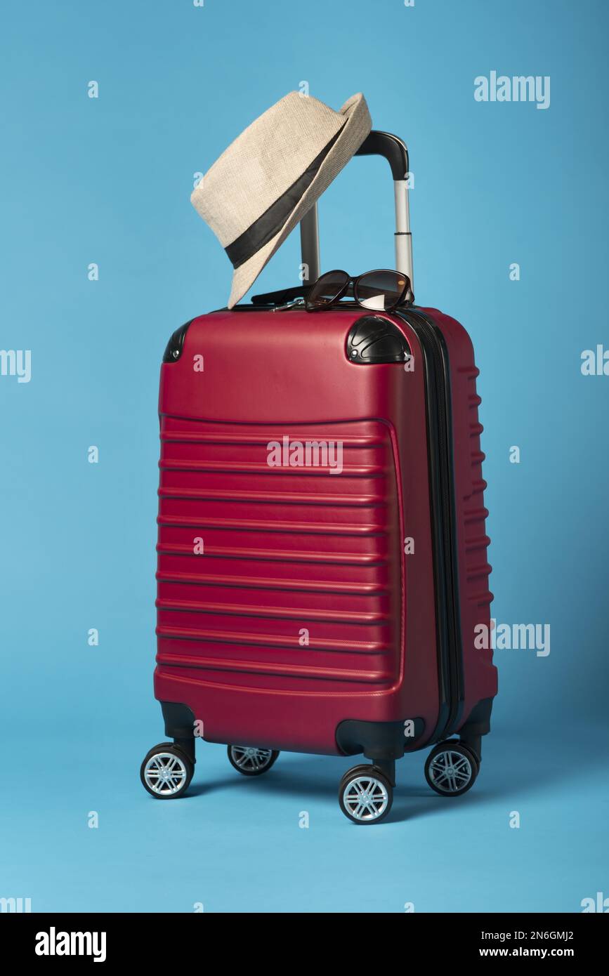 red luggage with blue background . Resolution and high quality