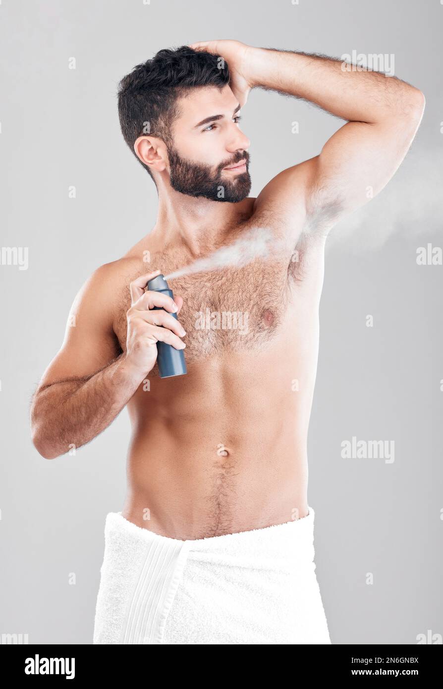Man, armpit and spray deodorant in studio for hygiene, fresh scent or