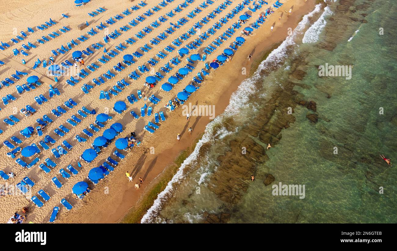 summer vacation and travel concept - beautiful aerial view of summer beach with tourists, sunbeds and umbrellas in Benidorm, Spain Stock Photo