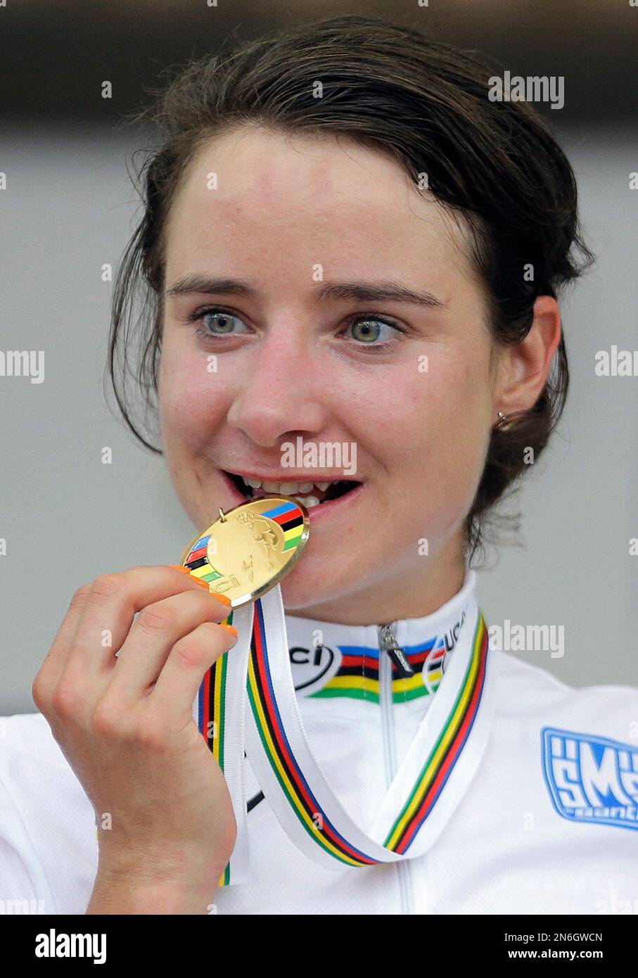 Dutch cyclist Marianne Vos bites the gold medal she won in the women's elite road race event, at