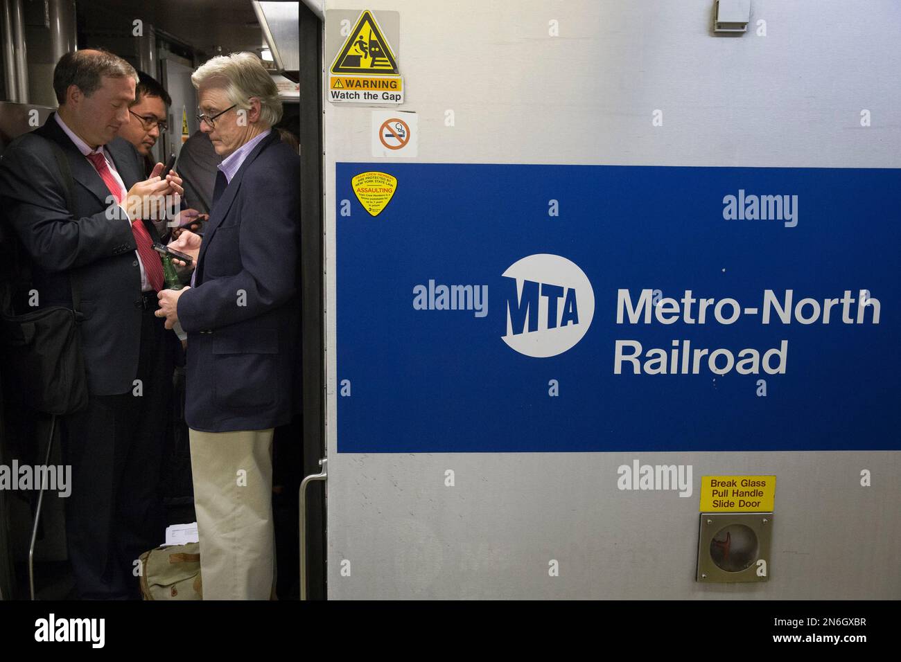 FILE This Sept. 25, 2013 photo, commuters stand in the doorway of a