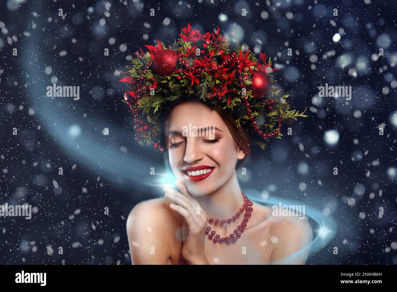 Beautiful young woman wearing Christmas wreath on dark background Stock Photo