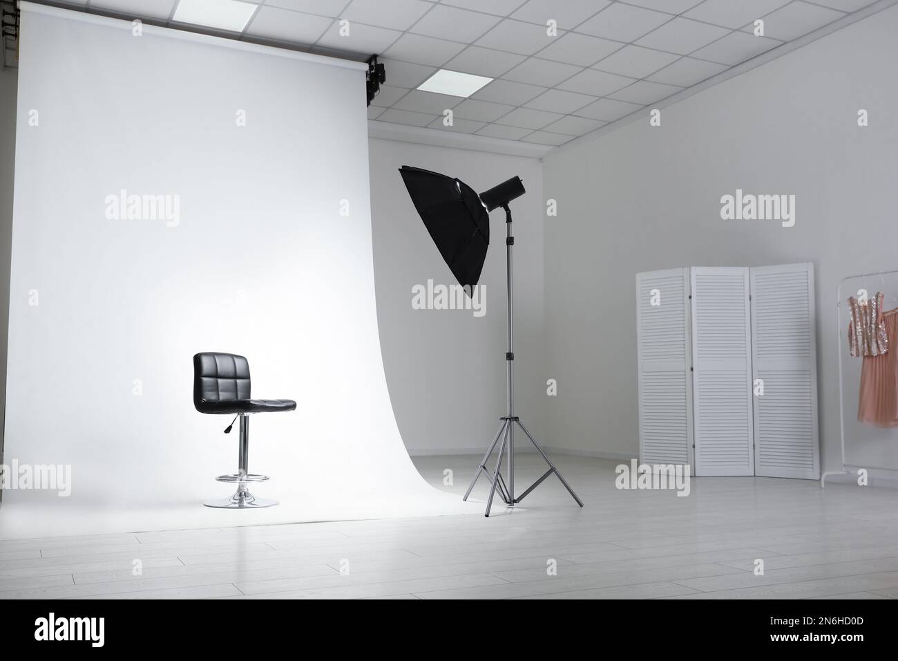 Photo studio interior with modern chair and professional lighting equipment Stock Photo