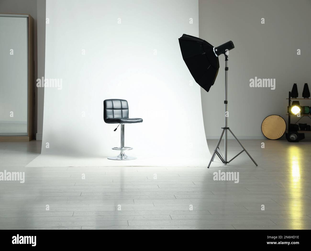 Photo studio interior with modern chair and professional lighting equipment Stock Photo