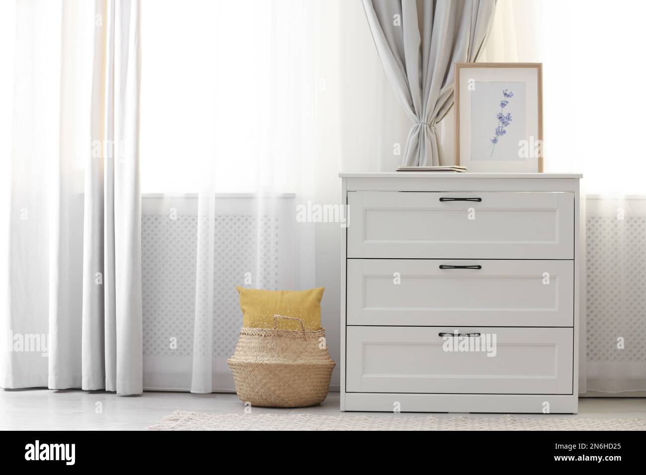 Chest of drawers near window with stylish curtains in living room ...