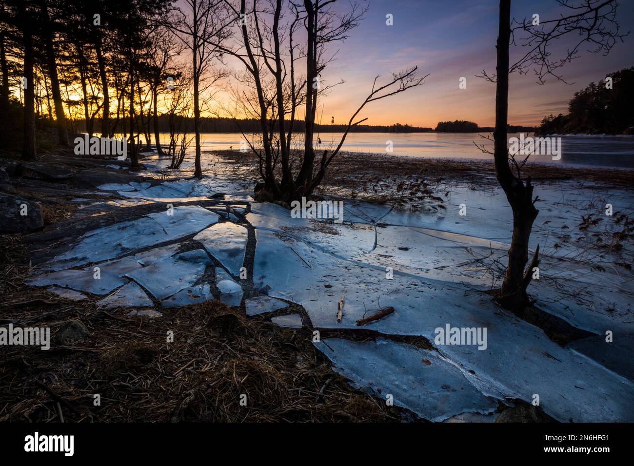 Ice formations and early morning winter sunrise by the lake Vansjø, Østfold, Norway, Scandinavia. Stock Photo