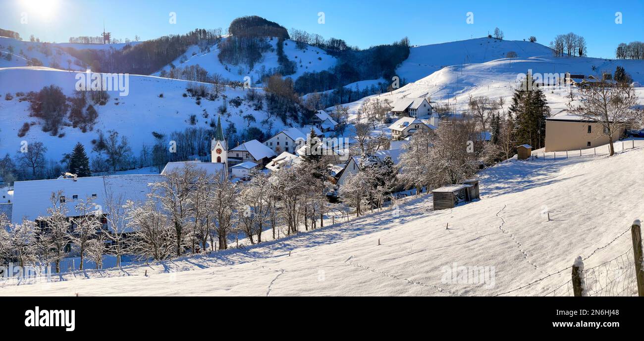 Winter village view with church, Wisen, Solothurn, Switzerland Stock Photo
