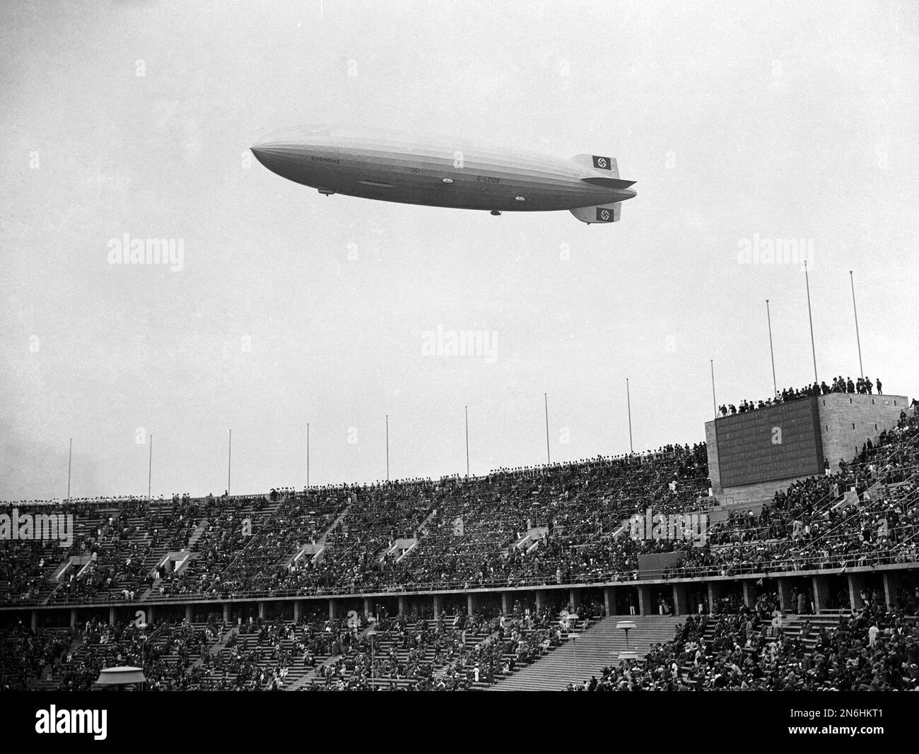 The German Airship Hindenburg Flies Over The Olympic Stadium Outside the-german-airship-hindenburg-flies-over-the-olympic-stadium-outside