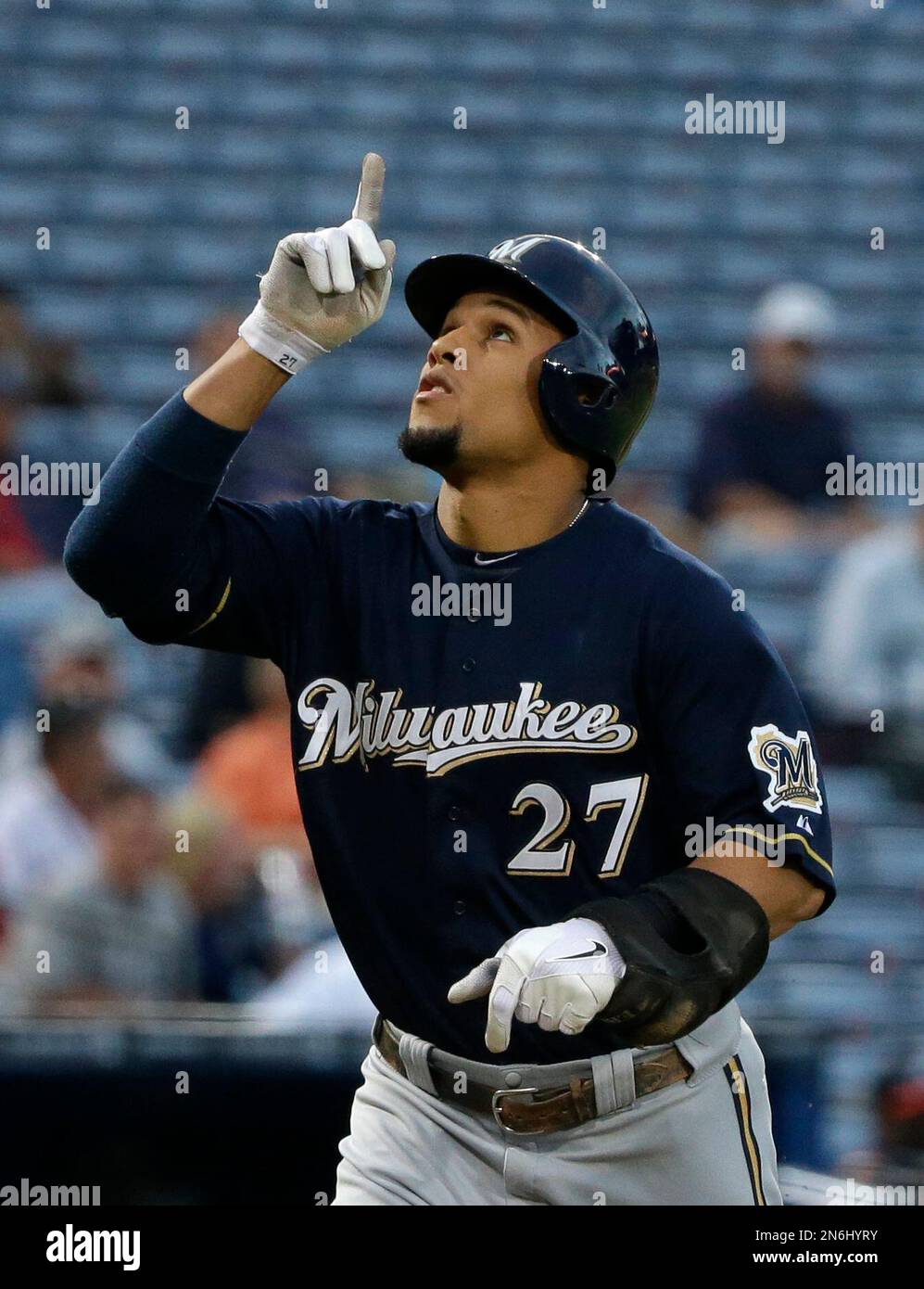 Milwaukee Brewers' Carlos Gomez points to the sky as he runs to home