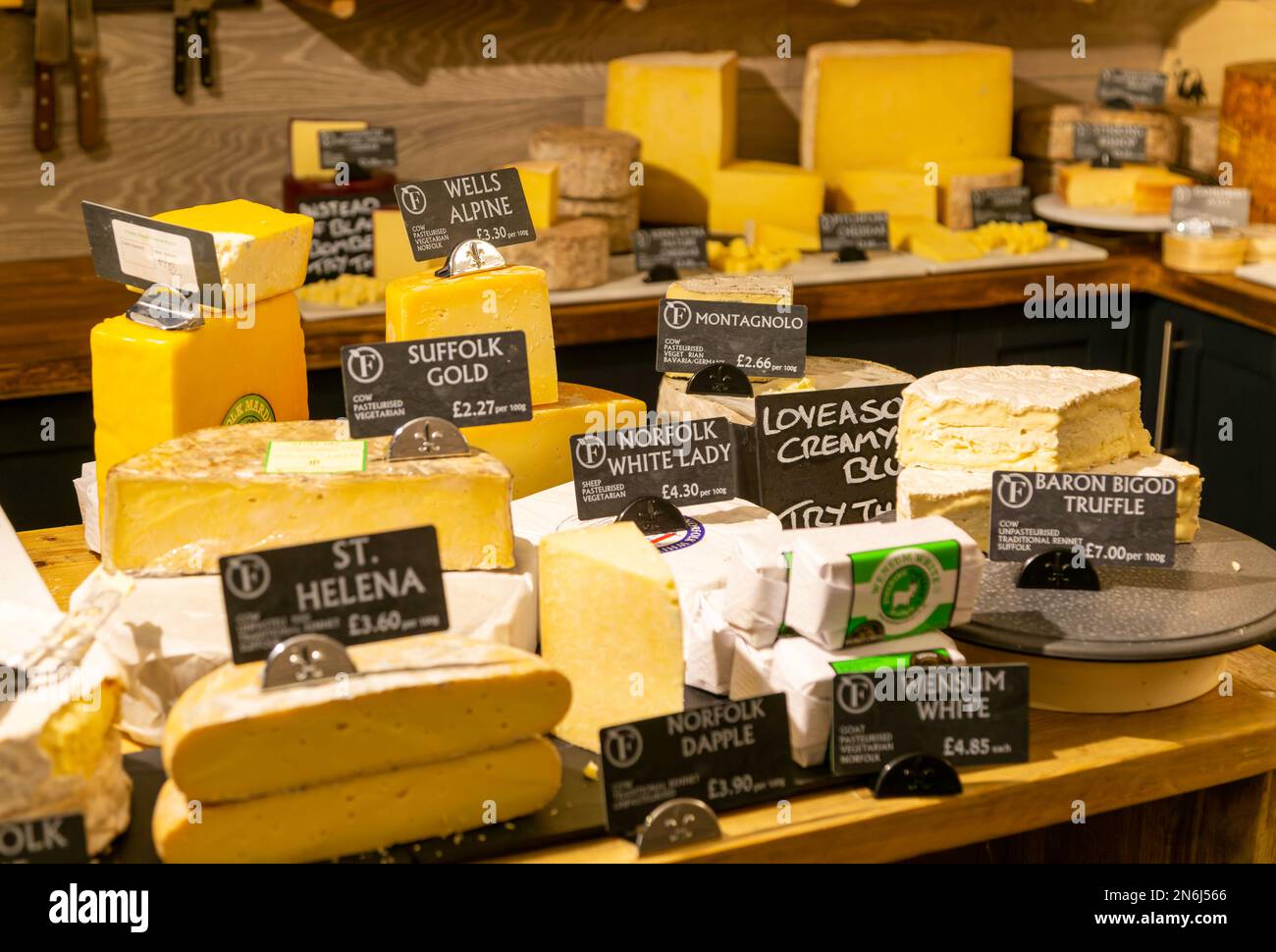 Variety of cheeses on display in cheese room of farm shop, Suffolk