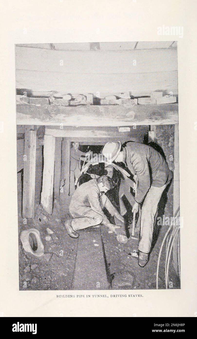 Building pipe in a tunnel Driving staves from the Article WOOD-STAVE PIPE FOR CONVEYING WATER By Arthur Lakes. from The Engineering Magazine DEVOTED TO INDUSTRIAL PROGRESS Volume IX April to September, 1895 NEW YORK The Engineering Magazine Co Stock Photo